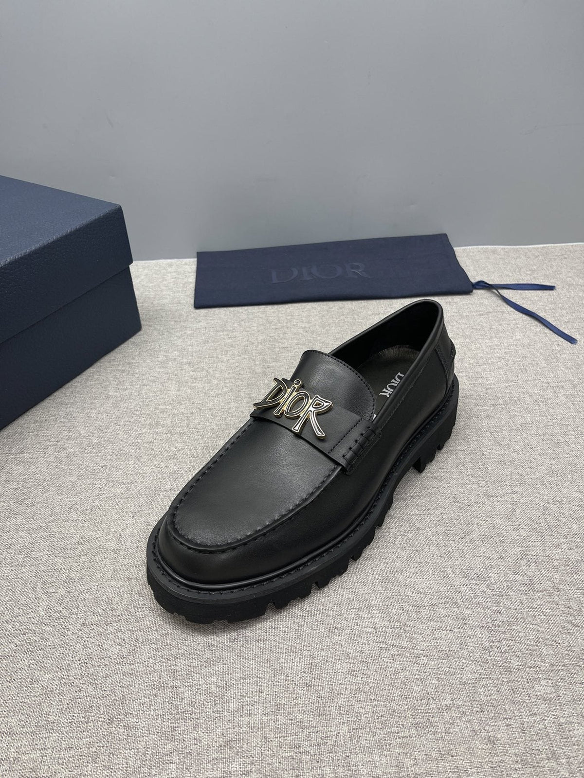 Dior Black Gold-Plaque Slip-On Shoes — side